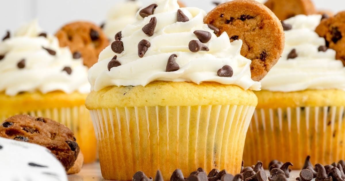 chocolate chips sprinkled on top of the cupcake and garnished with mini chocolate chip cookie