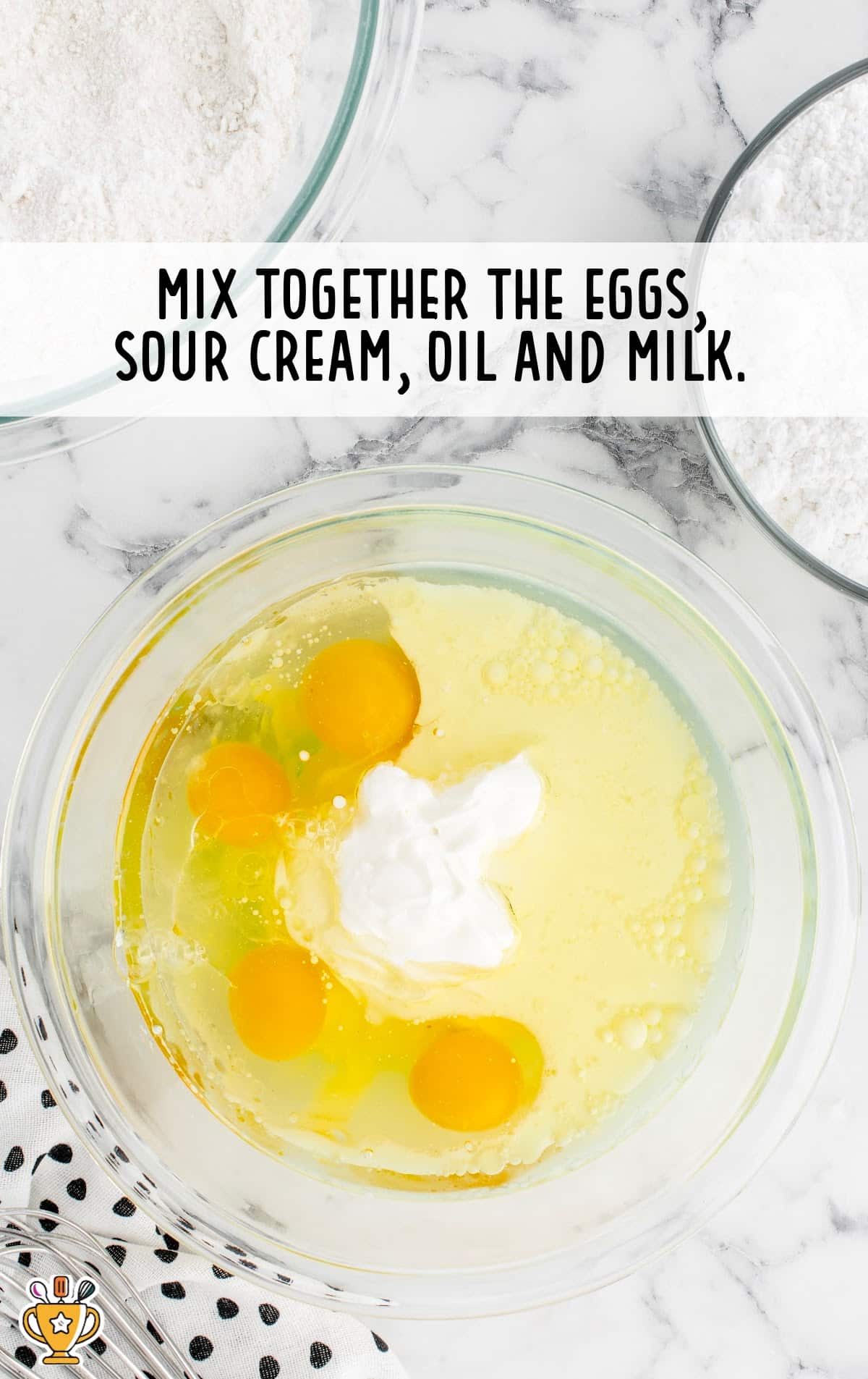 eggs, sour cream, oil, and milk combined in a bowl