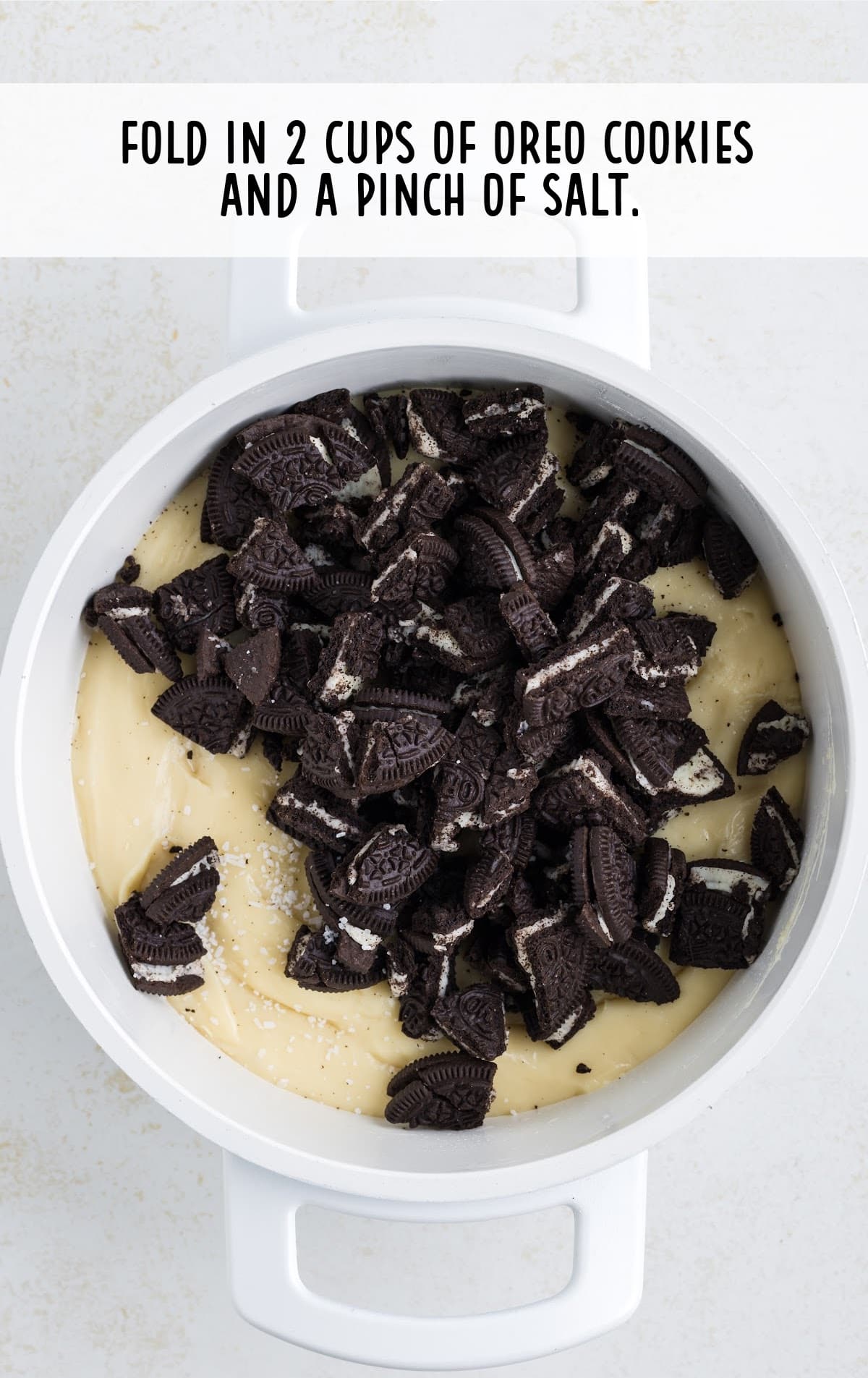 Oreo cookies and salt poured into a pot