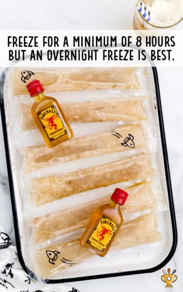 overhead shot of Fireball Whisky Popsicles and fireball bottle in a tray