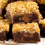 A serving plate full of sliced German Chocolate Brownies.