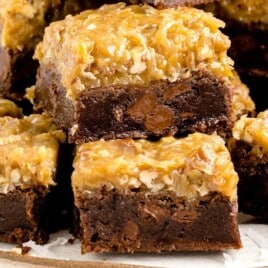 A serving plate full of sliced German Chocolate Brownies.