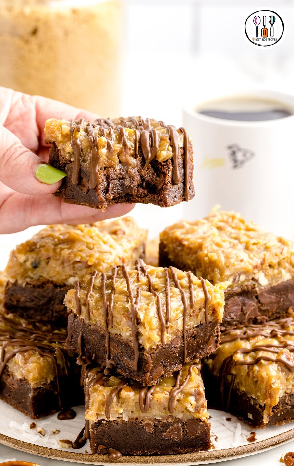 close up shot of German Chocolate Brownies stacked on top of each other on a tray with one having a bite taken out of it