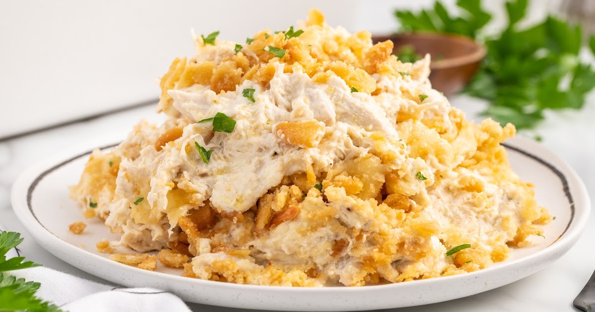 overhead shot of Corn Casserole on a baking dish with a spoon taking out a piece