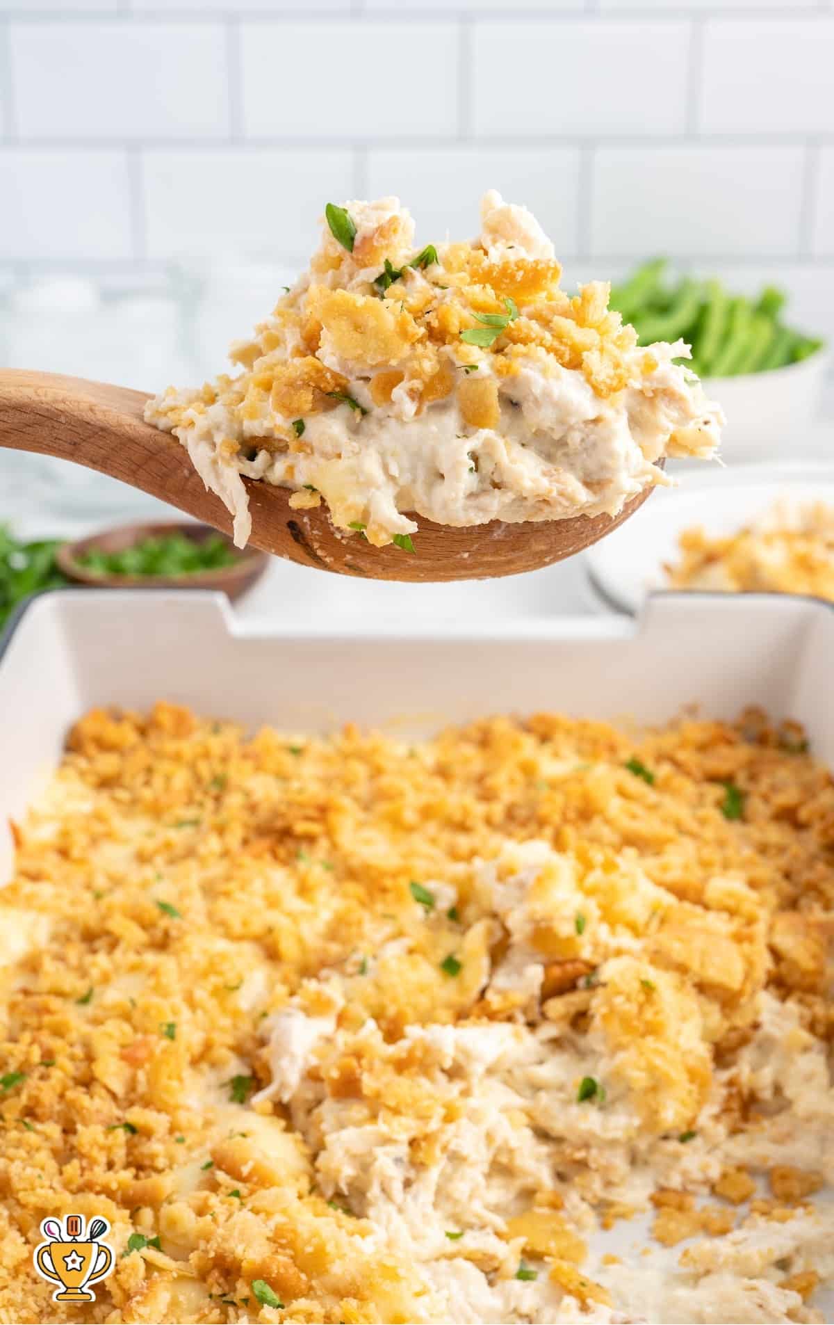 overhead shot of Corn Casserole on a baking dish with a spoon taking out a piece