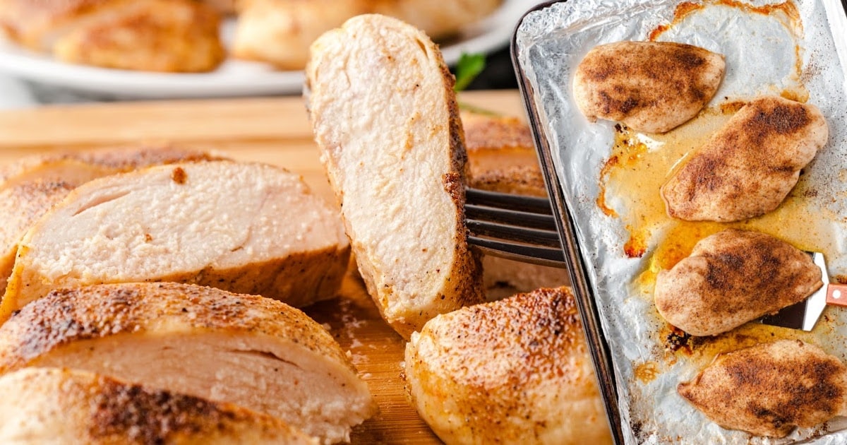 close up shot of a Oven Baked Chicken sliced on a wooden board