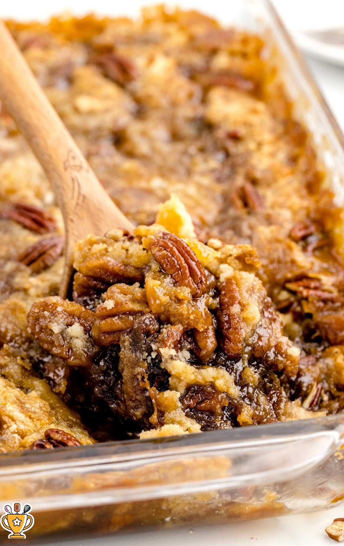 a close up shot of Pecan Dump Cake on a plate topped with ice cream