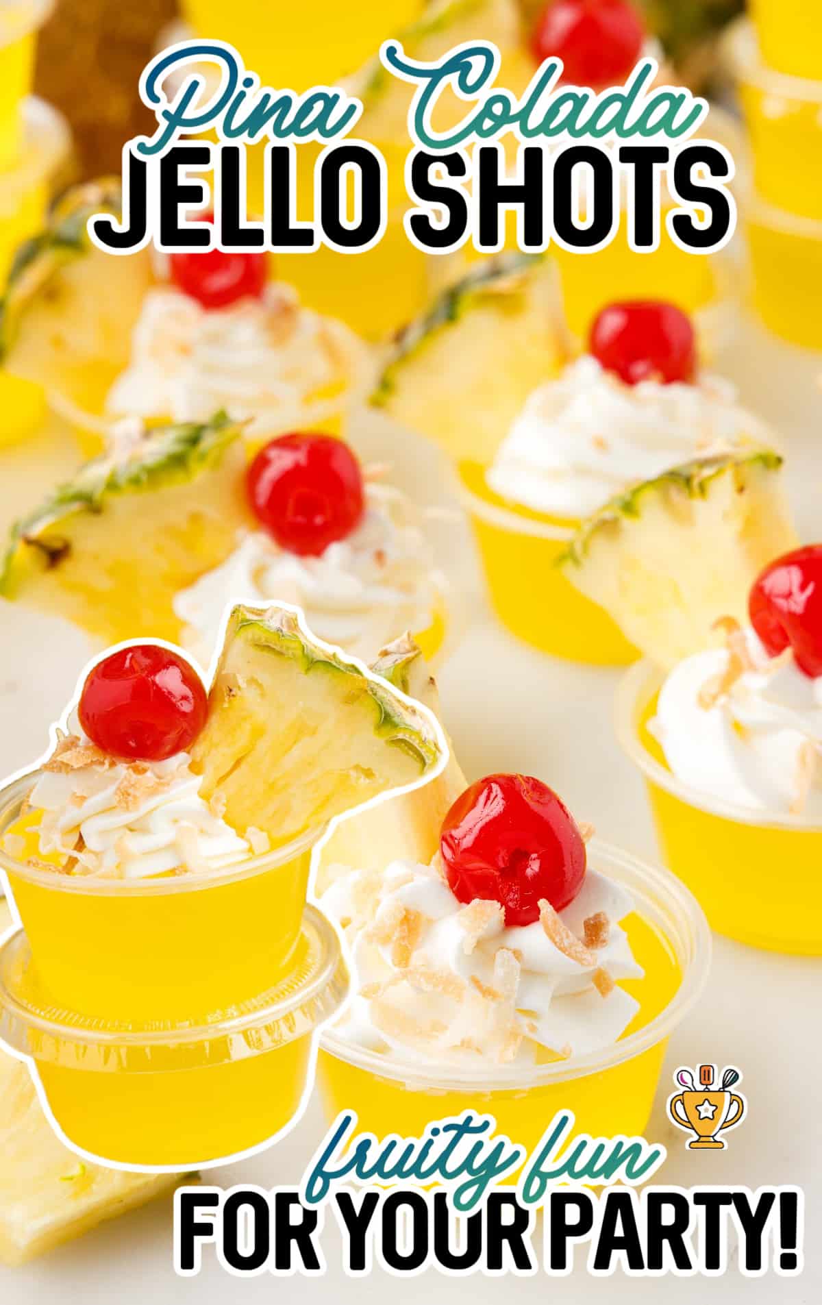 A close up of pina colada jello shots, decorated with cool whip and a cherry.