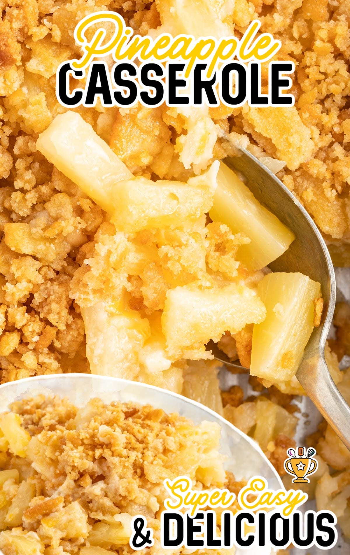 a overhead shot of Pineapple Casserole with a spoon grabbing a piece