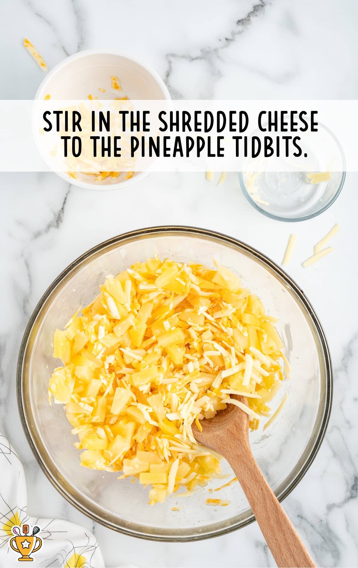 shredded cheese and pineapple tidbits stirred together