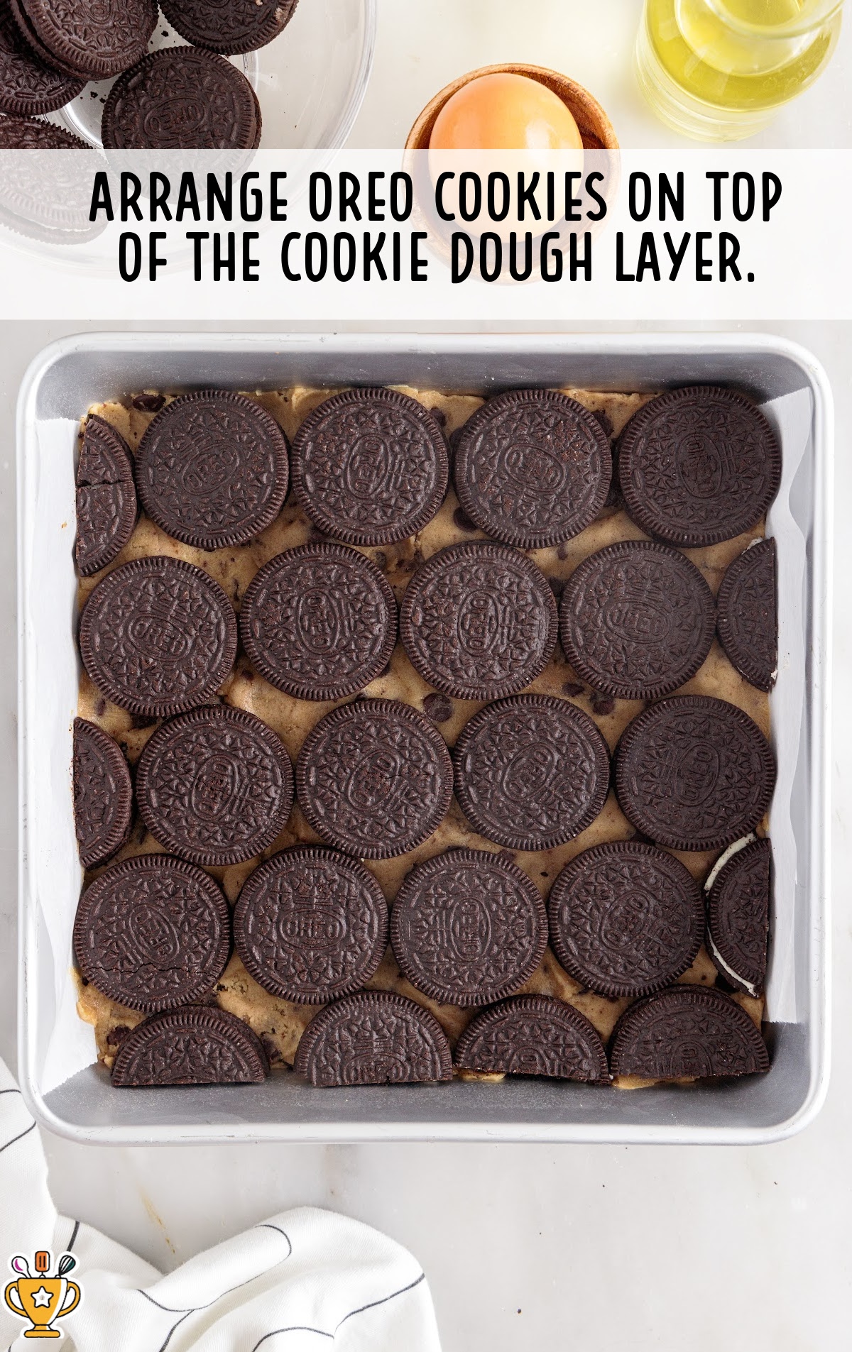oreo cookies arranged on top of the cookie dough layer