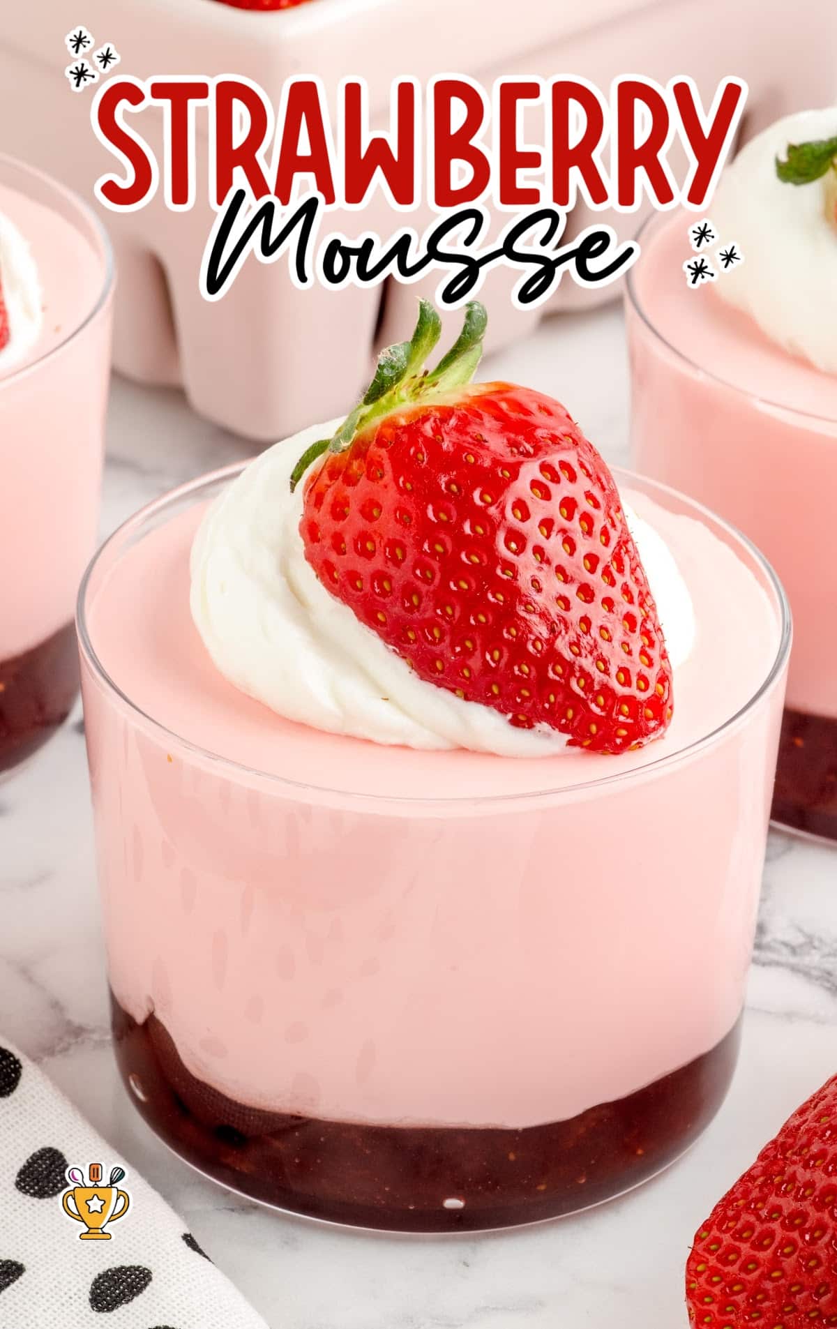 a close up shot of Strawberry Mousse in cup with a strawberry