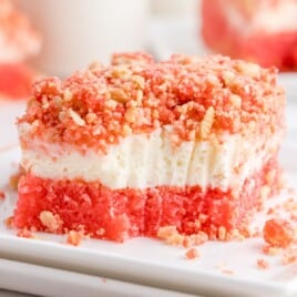 Close up shot of a strawberry brownie with a bite out of it.