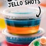 Colorful vodka Jello shots in small plastic cups, stacked and arranged on a platter for an easy party drink.