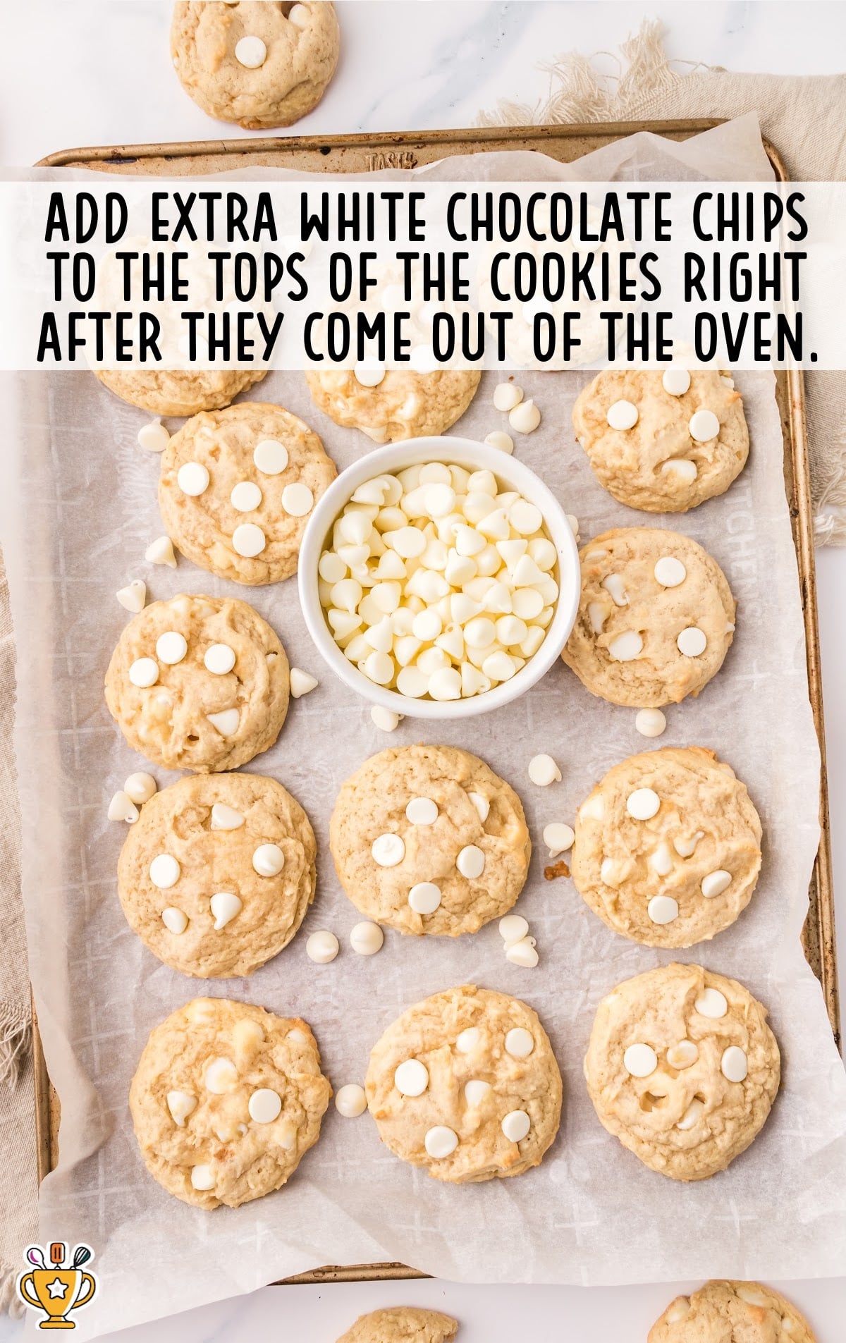 White Chocolate Chip Cookies on a baking dish with a bowl of White Chocolate Chips