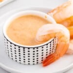 A close up of Yum Yum Sauce in a small bowl with a shrimp.