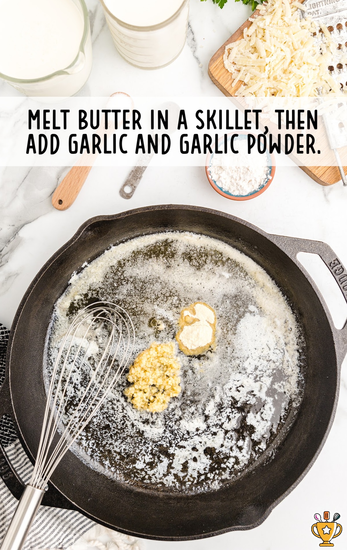 butter, garlic, and garlic powder being whisked together in a skillet