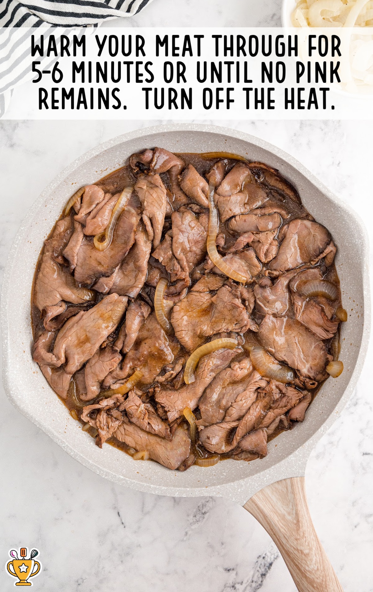 roast beef panini with au jus process shot of onions, butter, and seasonings in a skillet