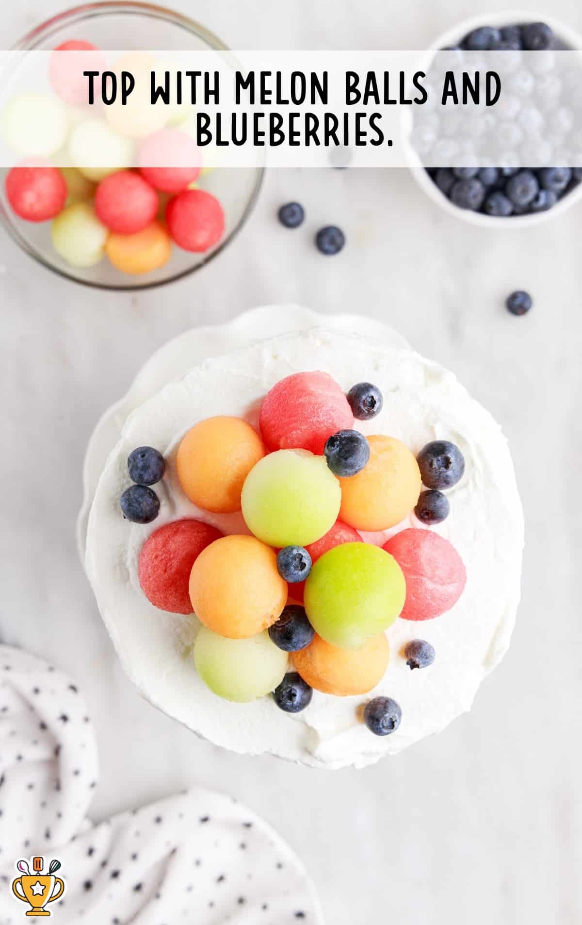 cake topped with melon balls and blueberries