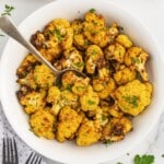 A white serving bowl of air fryer cauliflower.