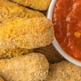 a pile of ready to eat mozzarella sticks cooked in the air fryer.