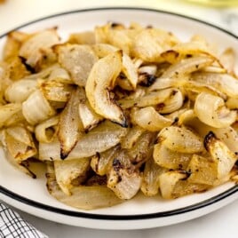 air fried onion pieces on a white plate.