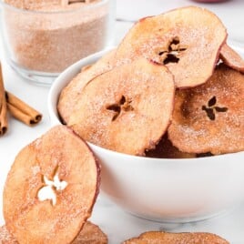 a white bowl of baked apple slices