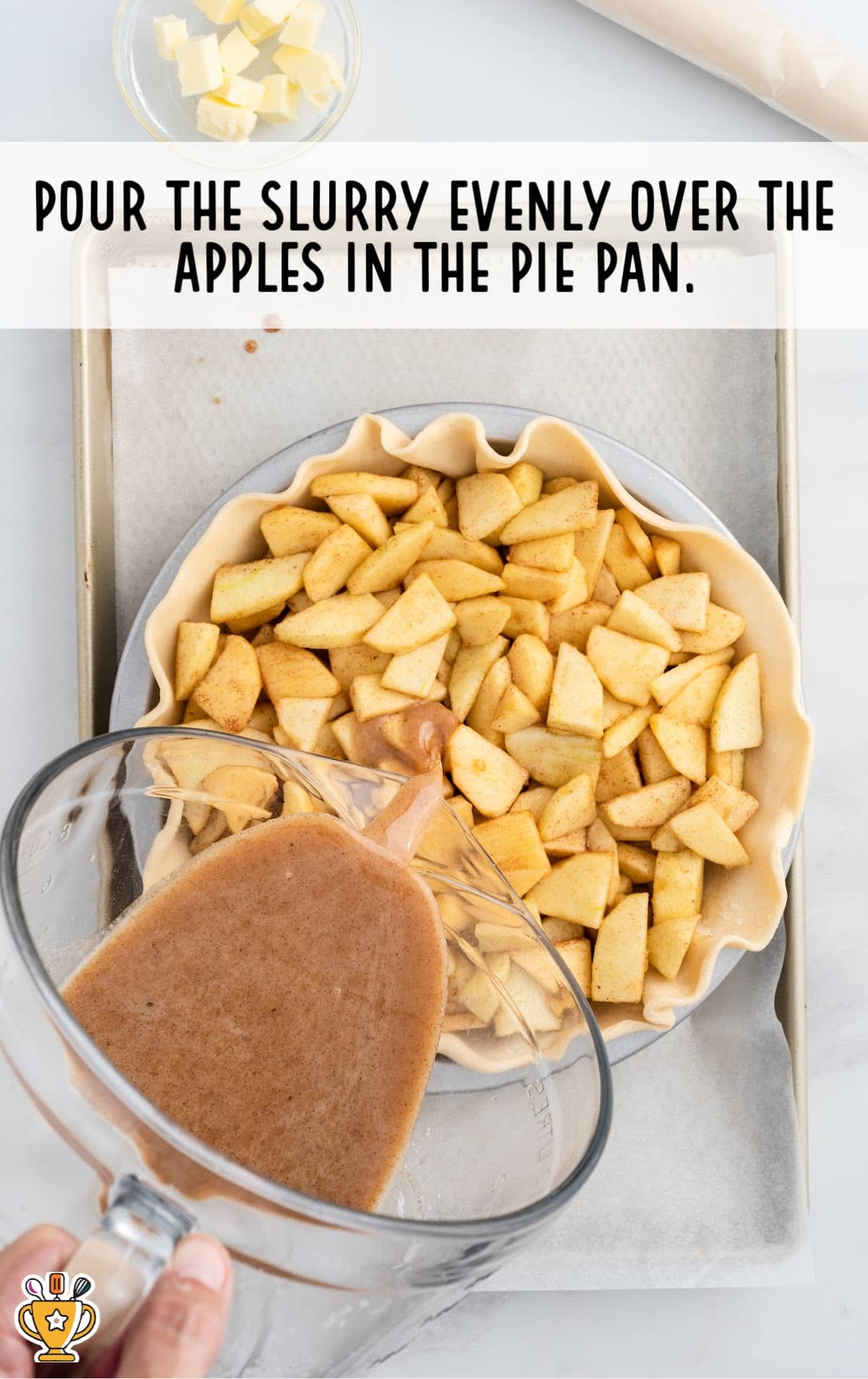 Pouring the Slurry over the Apples in a pie pan