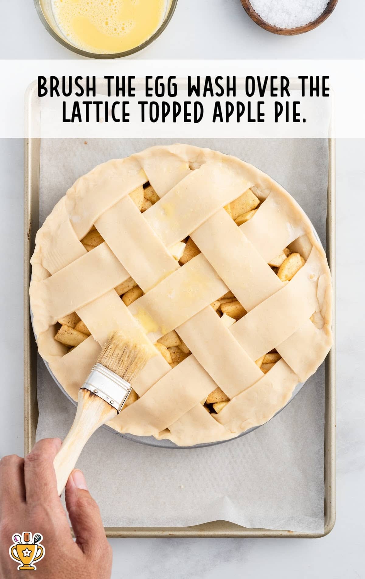 Brushing the Egg wash over the lattice topped apple pie