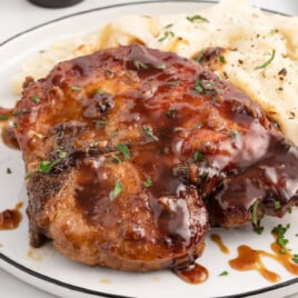 a dinner plate of pork chops with mashed potatoes