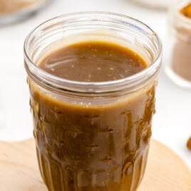 A jar full of brown sugar sauce.