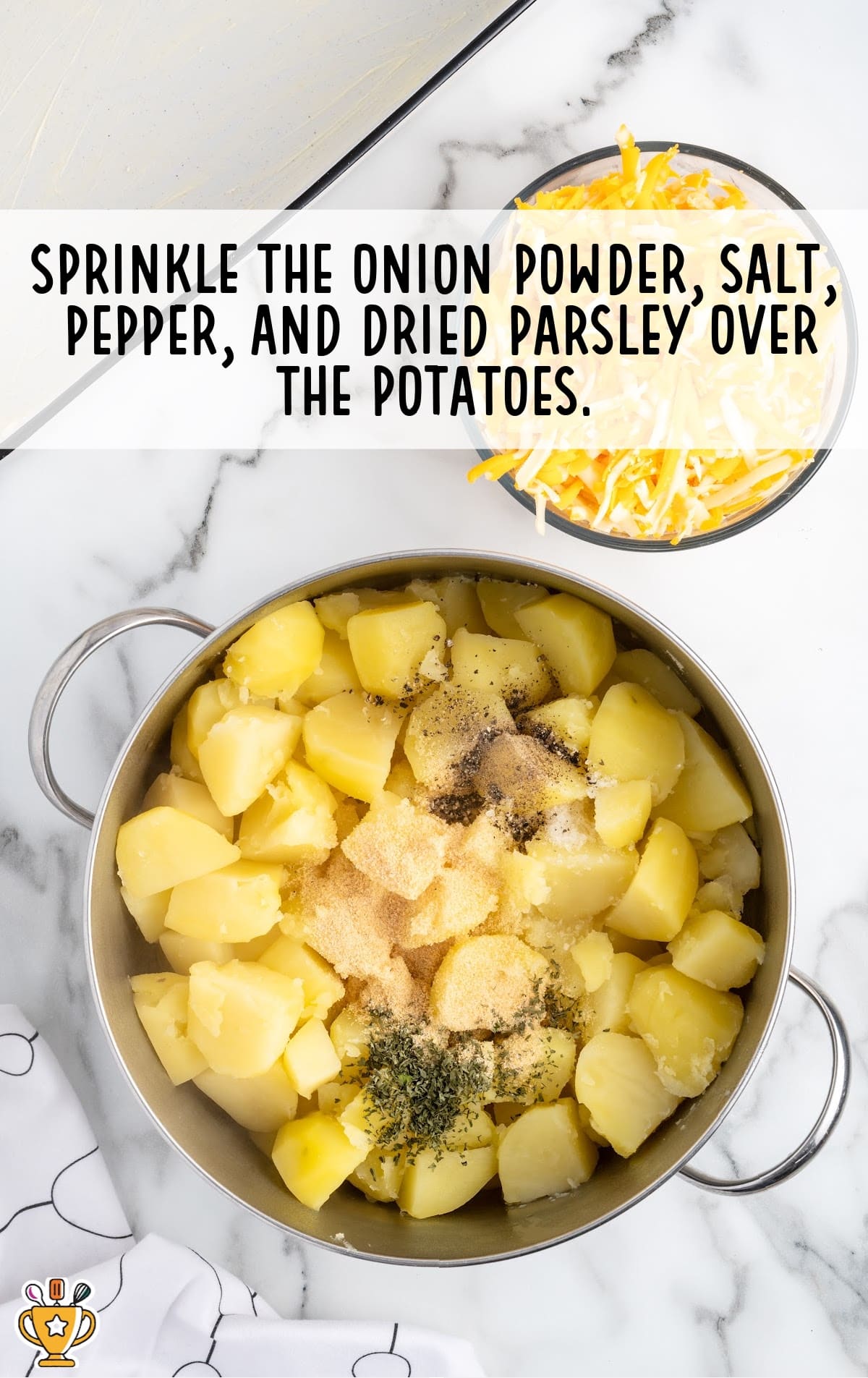 A pan of boiled potatoes with sprinkles of onion powder, salt, pepper and dried parsley