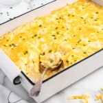 A baking tin of Cheesy Mashed Potatoes with spoon in it