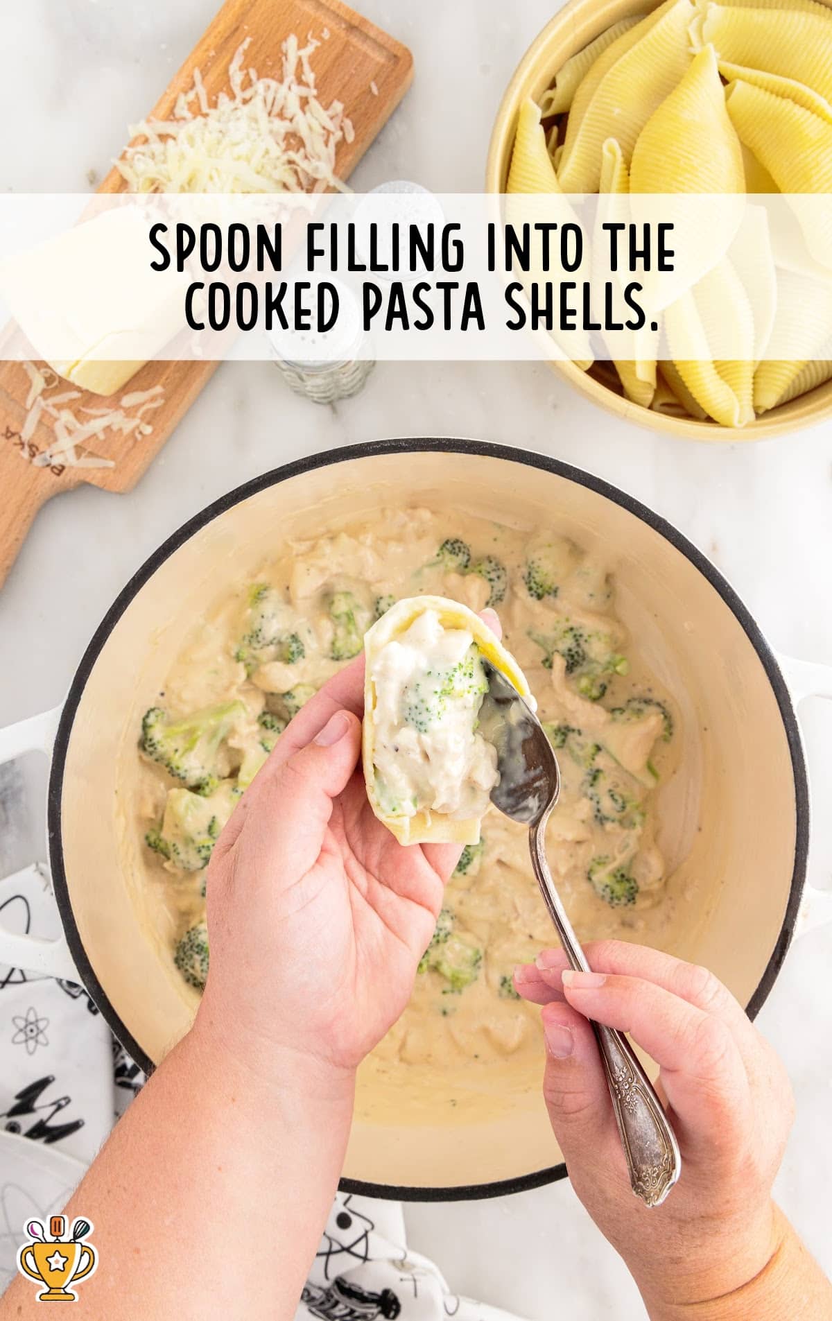 Spoon filling into the cooked pasta shells