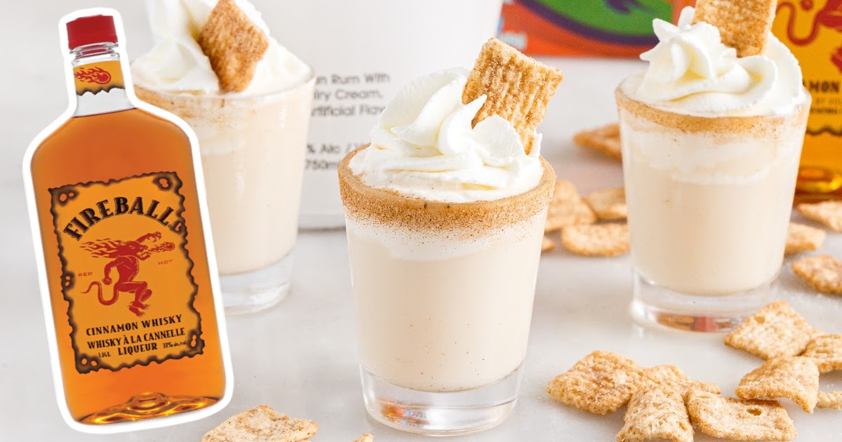 Cinnamon Toast Crunch Shot in two glasses with a bottle of fireballs cinnamon whisky on the side