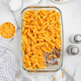 a glass casserole dish full of french fry casserole.