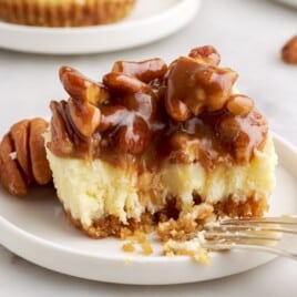 Mini Pecan Cheesecake Bite on a white plate with a fork