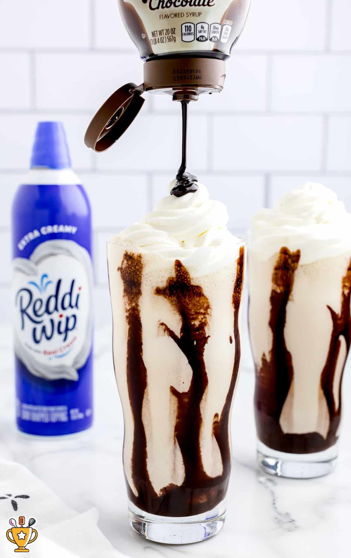 Two glasses of Mudslide with a drizzle of chocolate sauce from the top