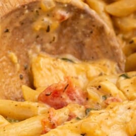 One Pot Chicken Pasta with a wooden spoon