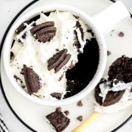 Oreo Mug Cake in a white mug over a white plate