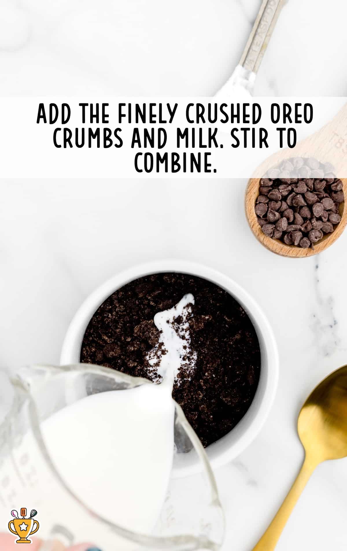 Milk poured into a mug of finely crushed oreo crumbs