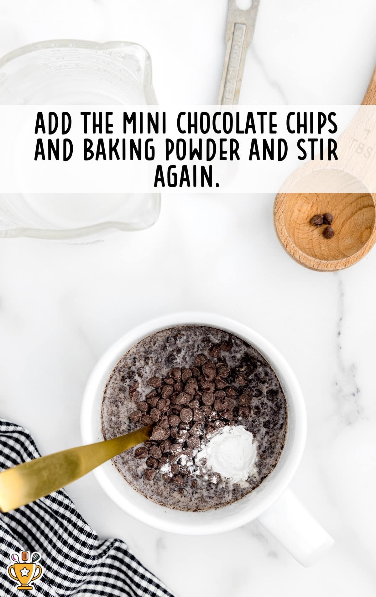 Mini chocolate chips and baking powder stirred together in a mug