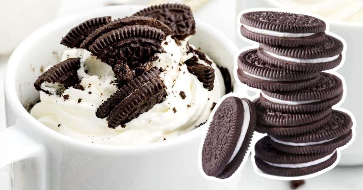 Oreo Mug Cake in a white mug with a bunch of oreo biscuits on the side