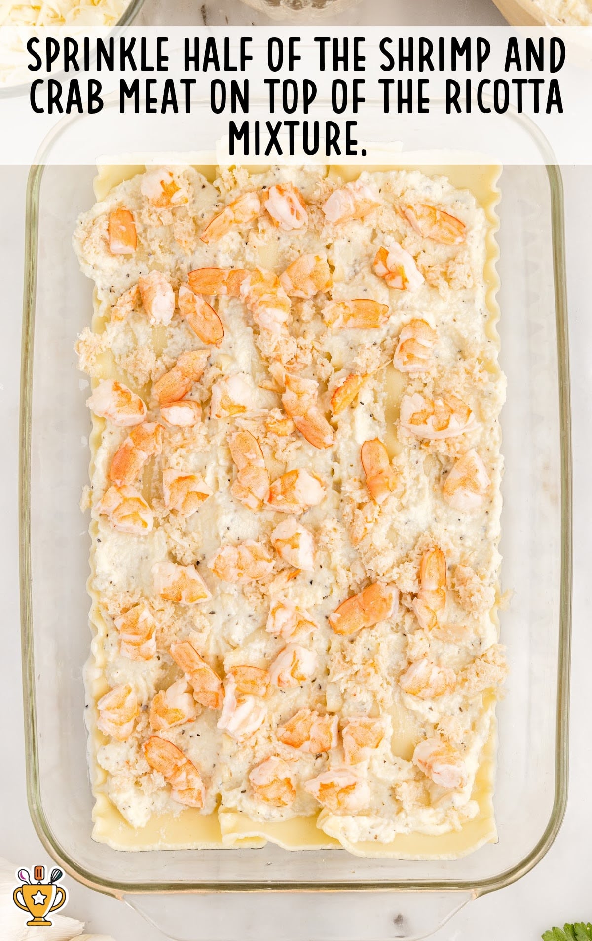 Shrimp and crab meat sprinkled on top of the ricotta mixture