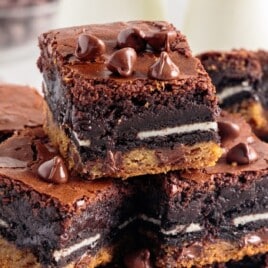 A stack of slutty brownies cut.