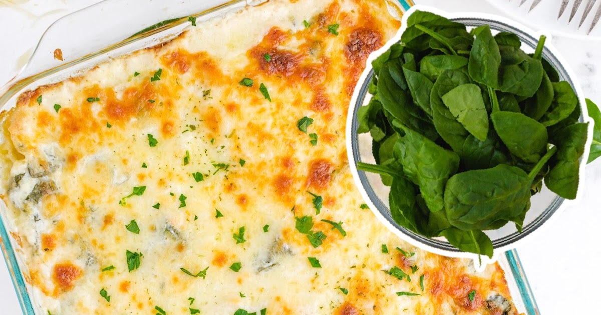 The top of a lasagna beside a bowl of spinach.