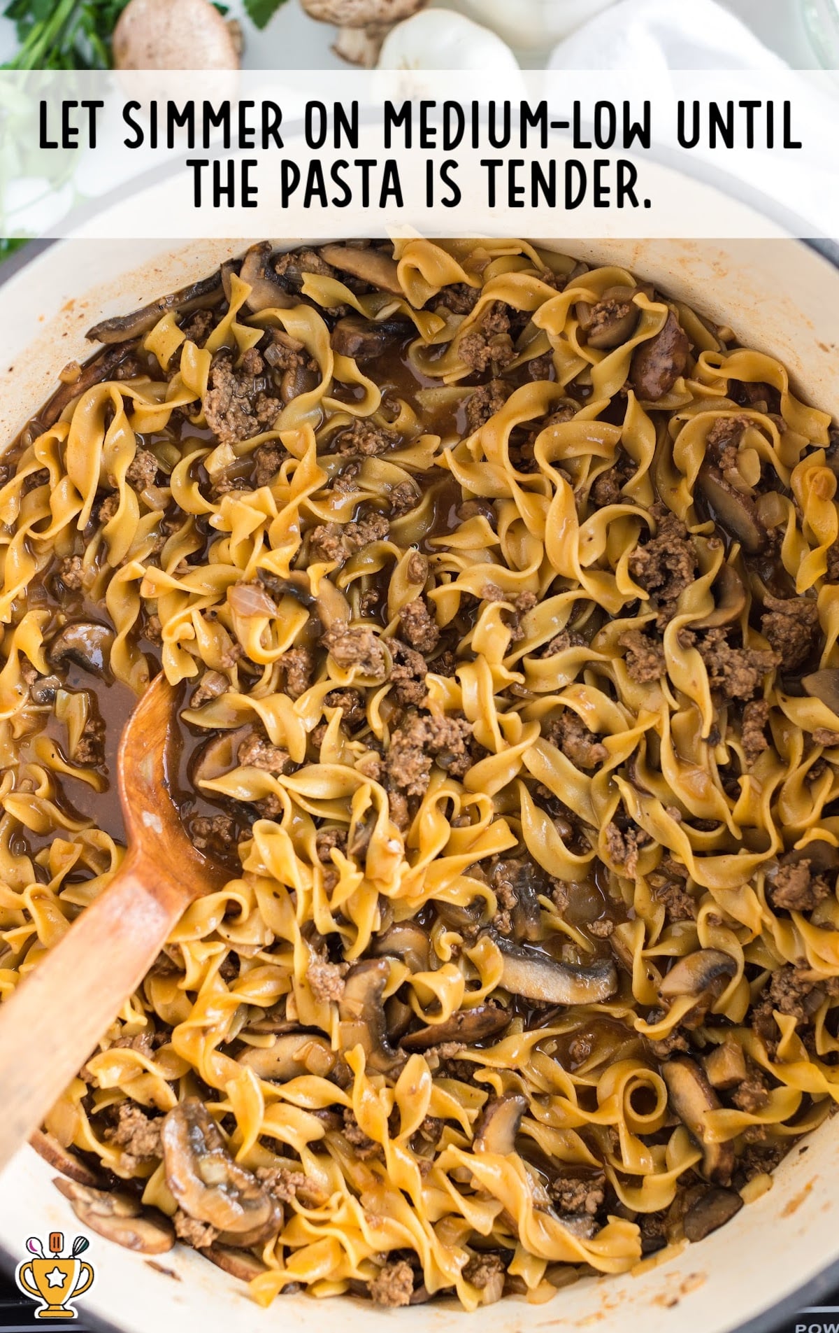 Ground Beef Stroganoff in a pan with a wooden spoon