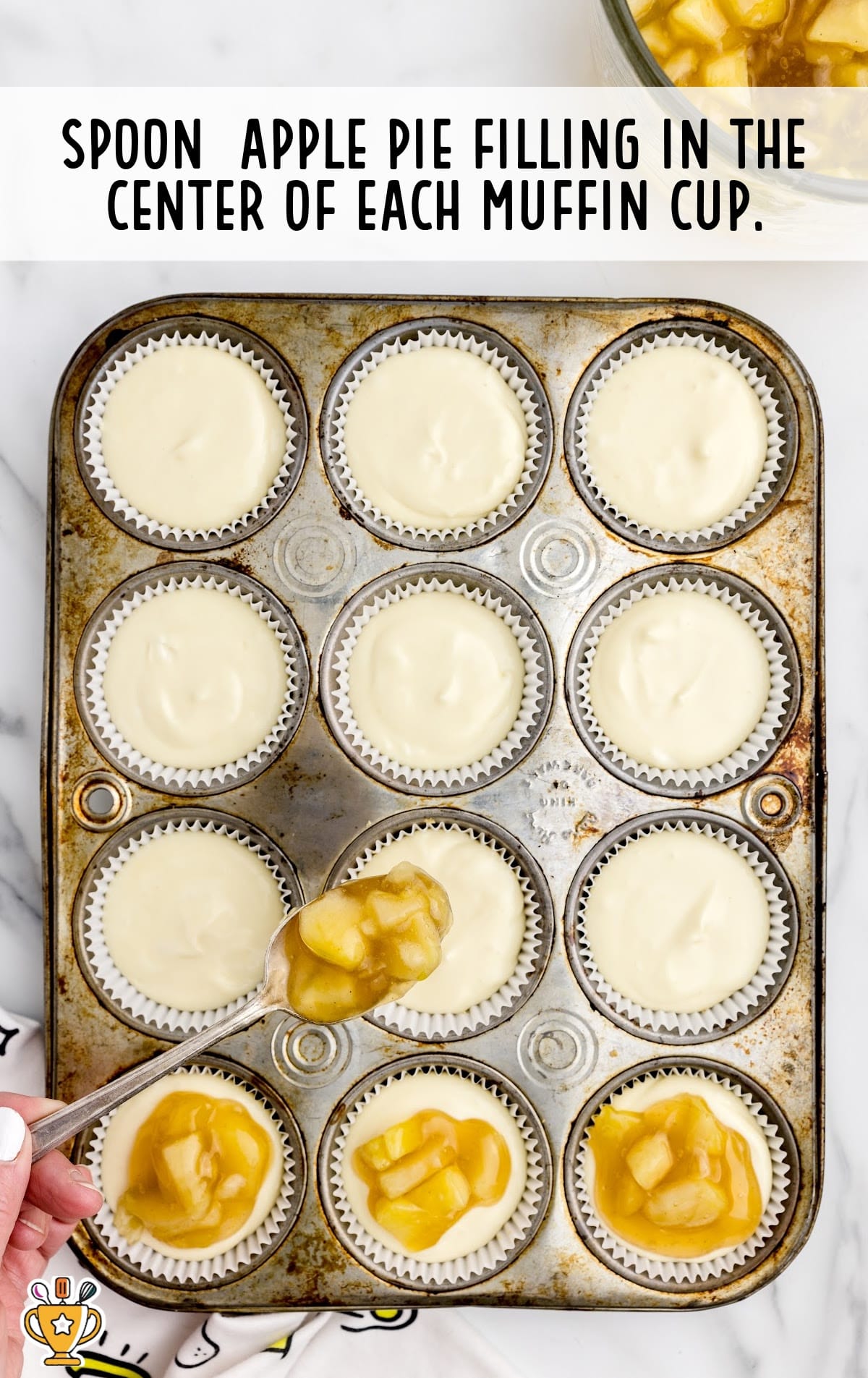 Apple pie filling in the center of muffin cups