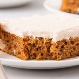 A piece of Pumpkin Sheet Cake on a plate with a fork