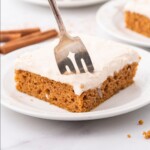 A piece of Pumpkin Sheet Cake on a plate with a fork